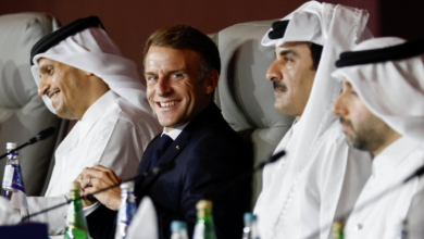 الرئيس الفرنسي إيمانيول ماكرون يبتسم يجلس إلى جواره أمير قطر الشيخ تميم بن حمد آل ثاني، وإلى يمين ماكرون وزير خارجية قطر الشيخ محمد بن عبد الرحمن بن جاسم آل ثاني