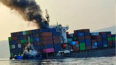 Photo: GFS PRIDE appears partially submerged as smoke rises from container ship